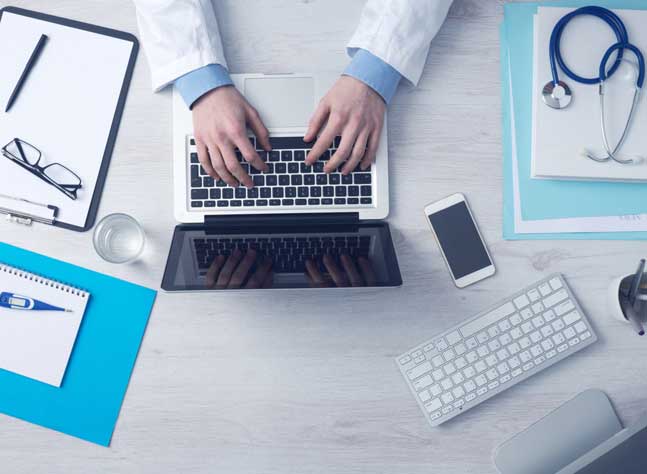 Medical Expense Billing work with Laptop, Mobile Phone, Stethoscope and Medical Documents