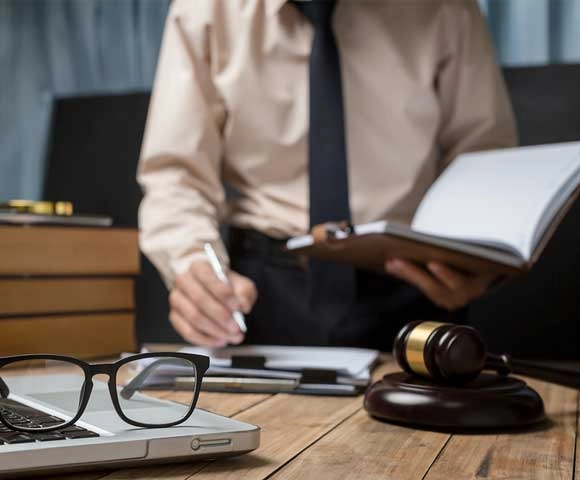 Attorney and medical consultant analyzing occupational injury records for a workers' compensation claim