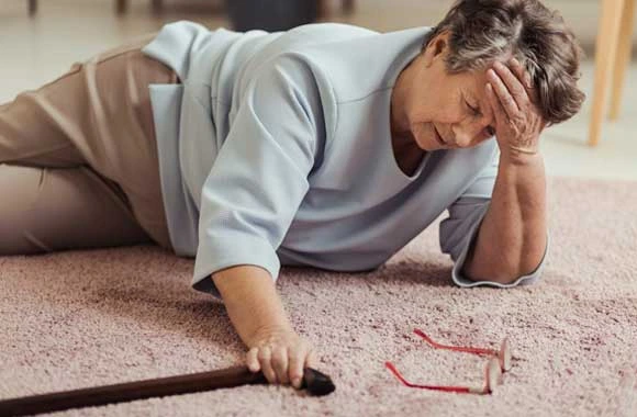 A wet floor sign and an elderly patient representing nursing home slip and fall accidents